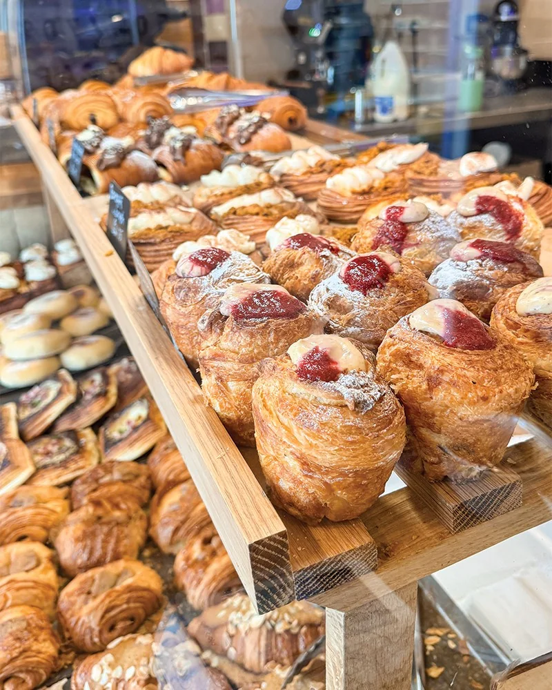A long counter filled with pastries at The Daily Knead