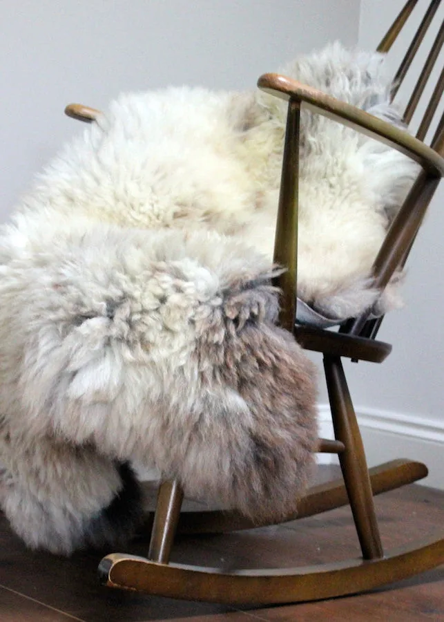 Sheepskin draped over a wooden chair in an official product photograph