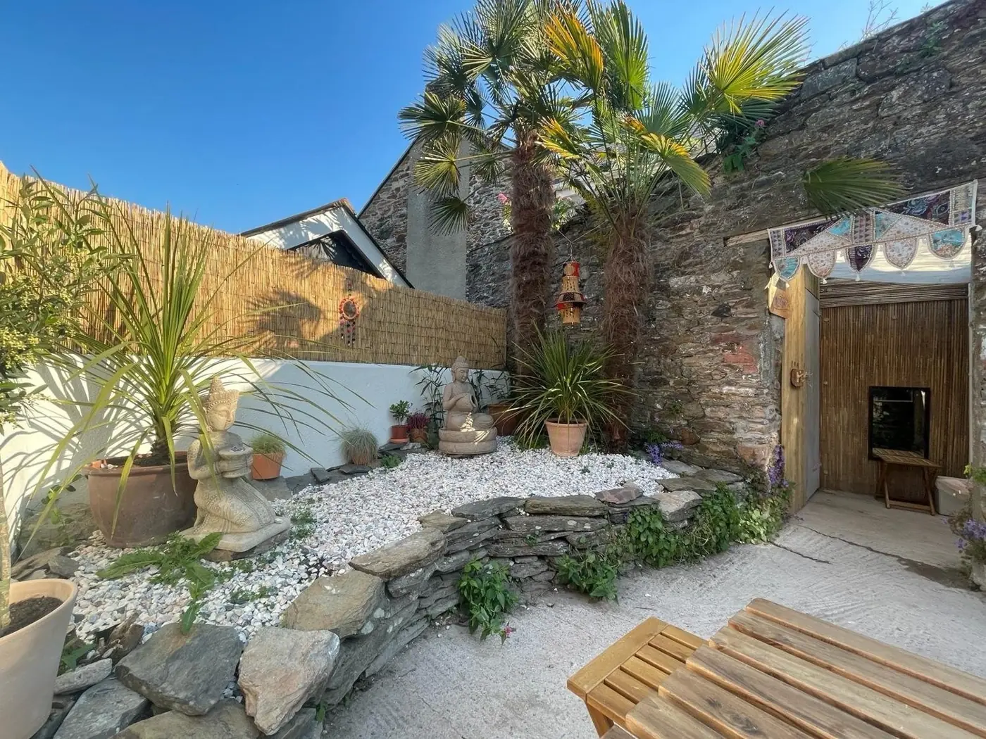 Palms and whitewashed walls in The Hairy Barista courtyard