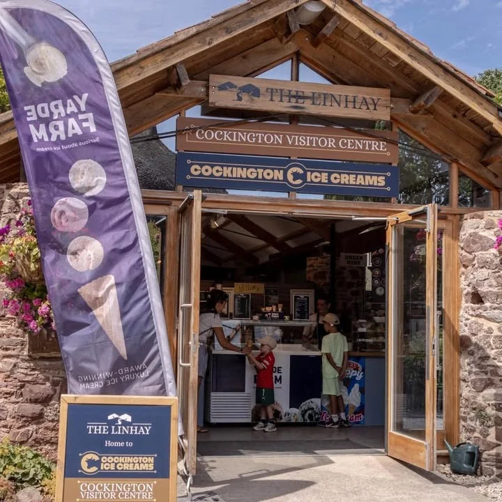 The Linhay entrance with Cockington Ice Creams and visitor centre signs