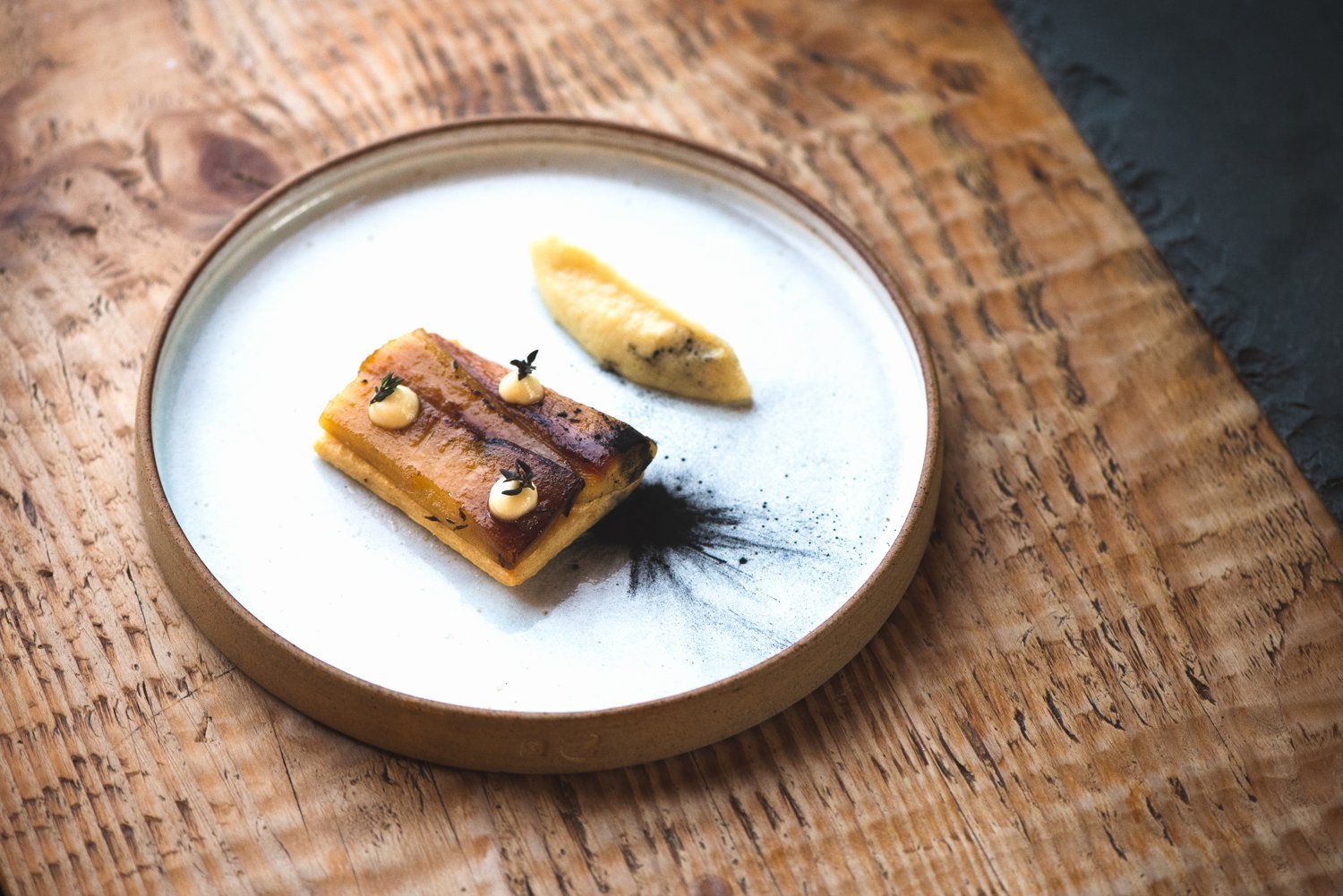 A carefully plated dish on a wooden table at The Old Library