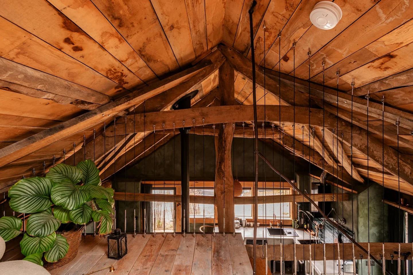 Timber-lined mezzanine with a view across the open barn interior