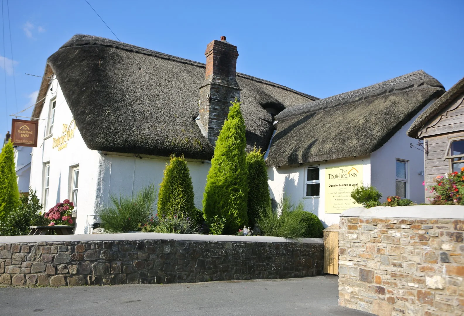 Whitewashed Thatched Inn exterior beneath its thatched roof