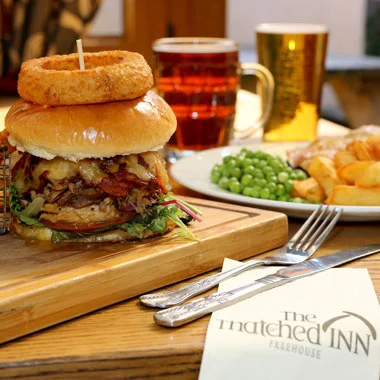 Burger and drinks photographed at the Thatched Inn