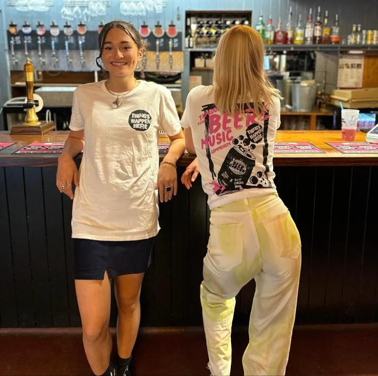 Two team members at the bar at Things Happen Here
