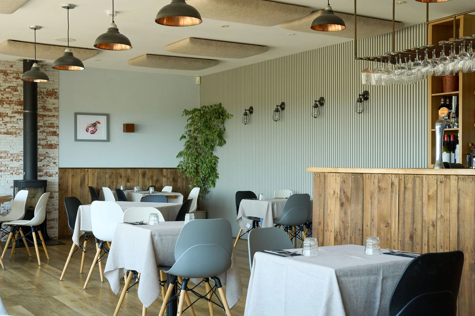 Tables and bar inside Thirty Three by the Sea’s light dining room