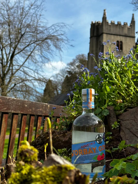 An Aurantiaco bottle photographed in a church garden