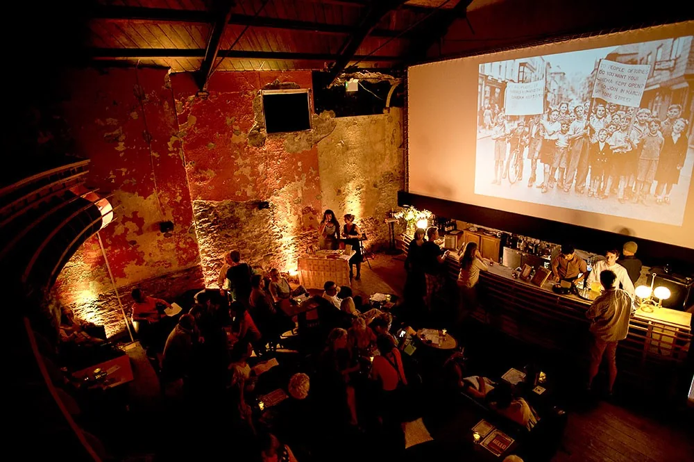 Audience seated beneath the balcony and large screen at Totnes Cinema