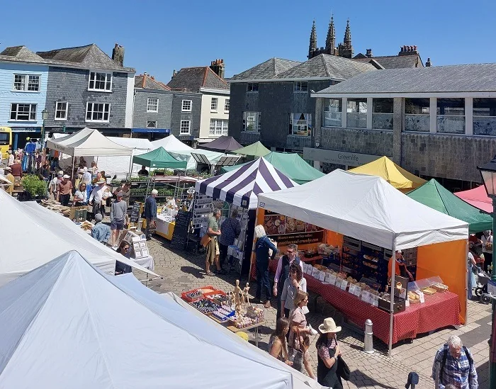 Colourful market canopies filling Totnes Market Square