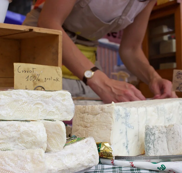 Cheeses displayed at a Totnes market stall