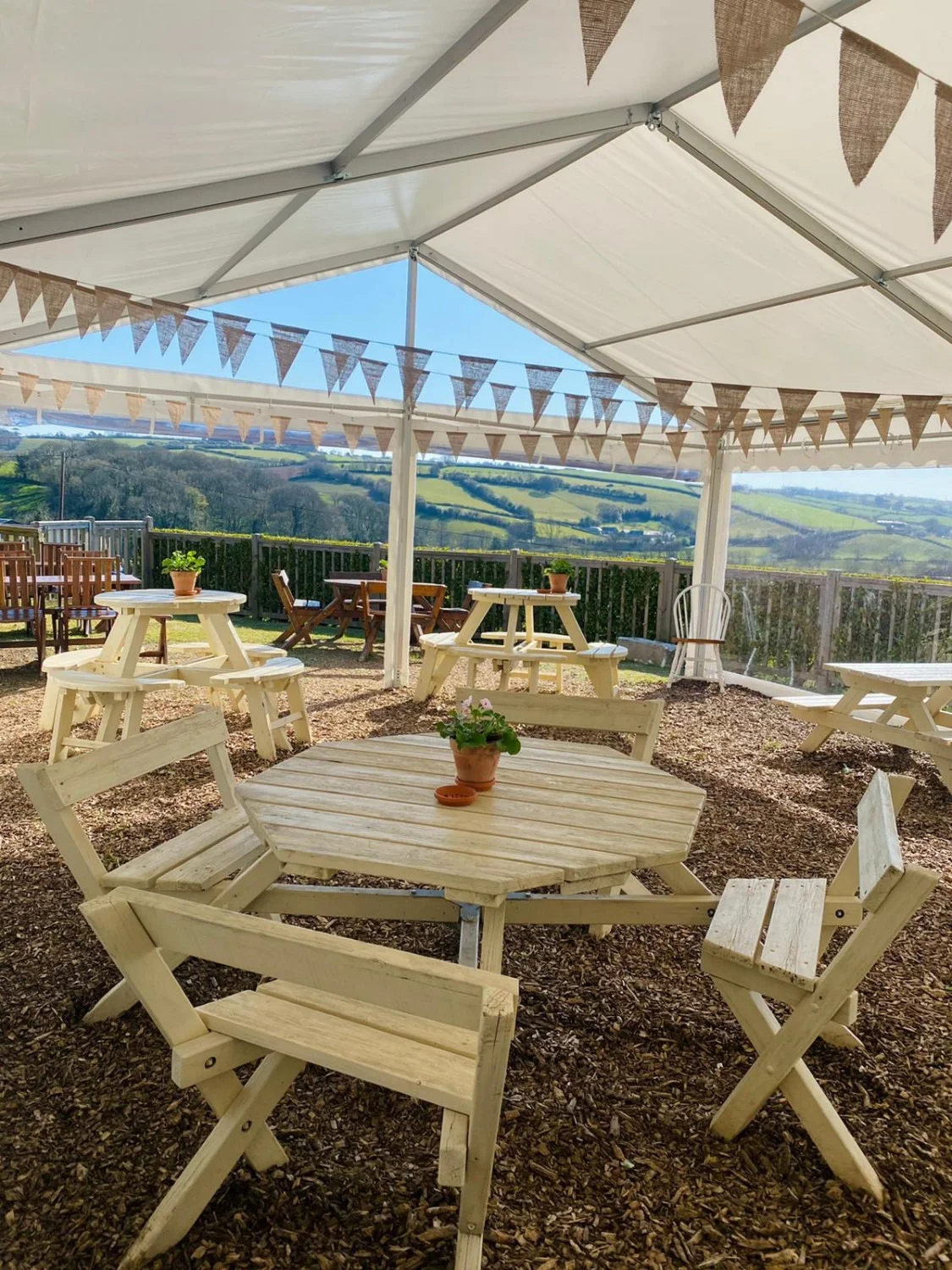 Covered picnic tables overlooking countryside