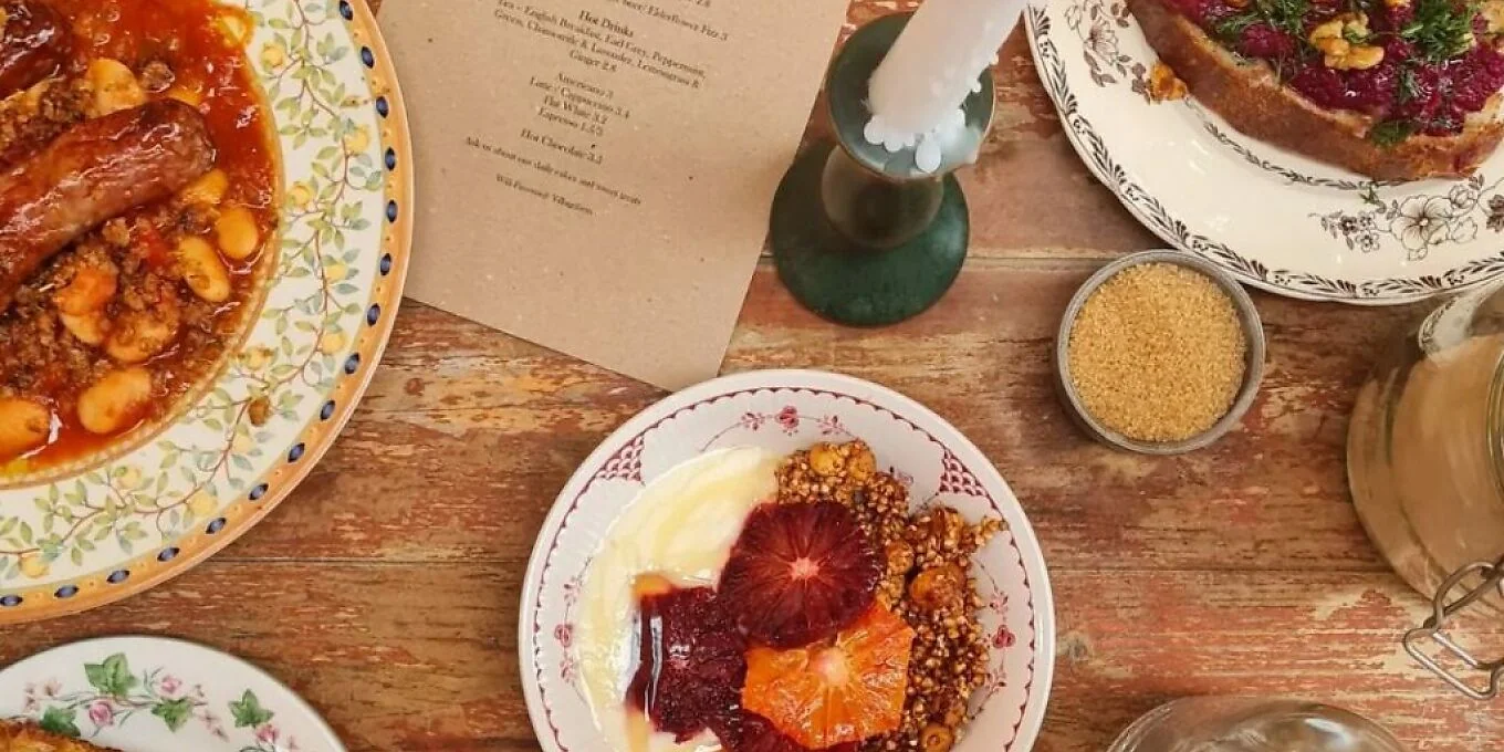 Colourful dishes and drinks spread across a café table