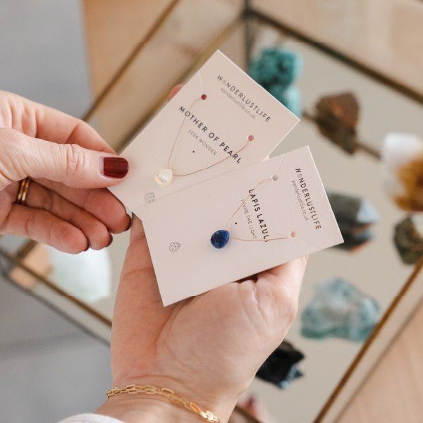 Gemstone jewellery displayed on cards inside Wanderlust Life