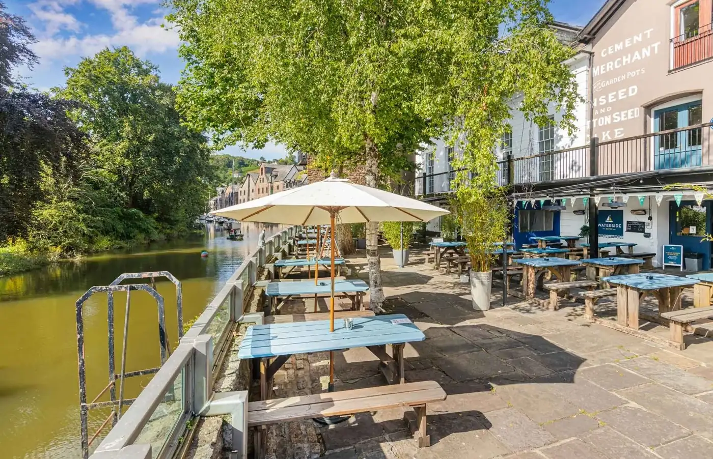 Outdoor tables overlooking the River Dart at Waterside Bistro