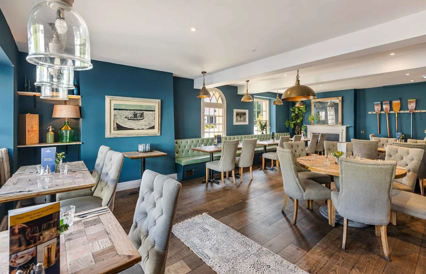 A bright dining room with blue walls at Waterside Bistro