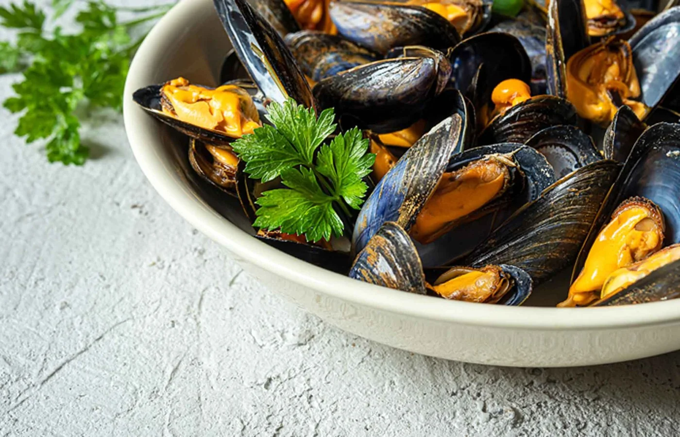 A bowl of mussels with herbs at Waterside Bistro