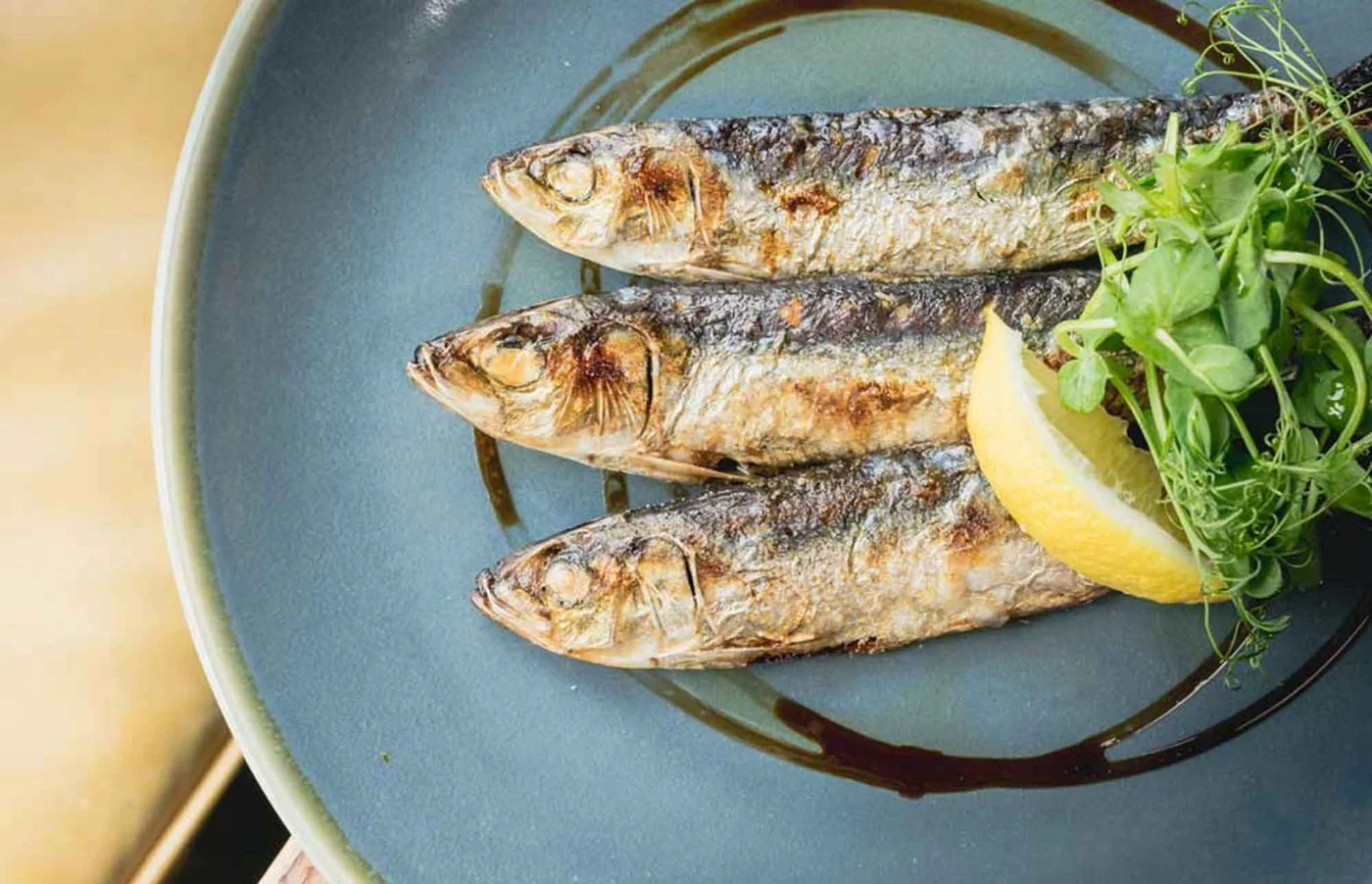 A plate of grilled fish with lemon at Waterside Bistro