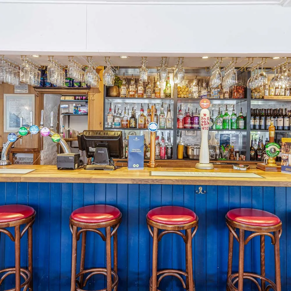 The blue-fronted bar with red stools at Waterside Bistro