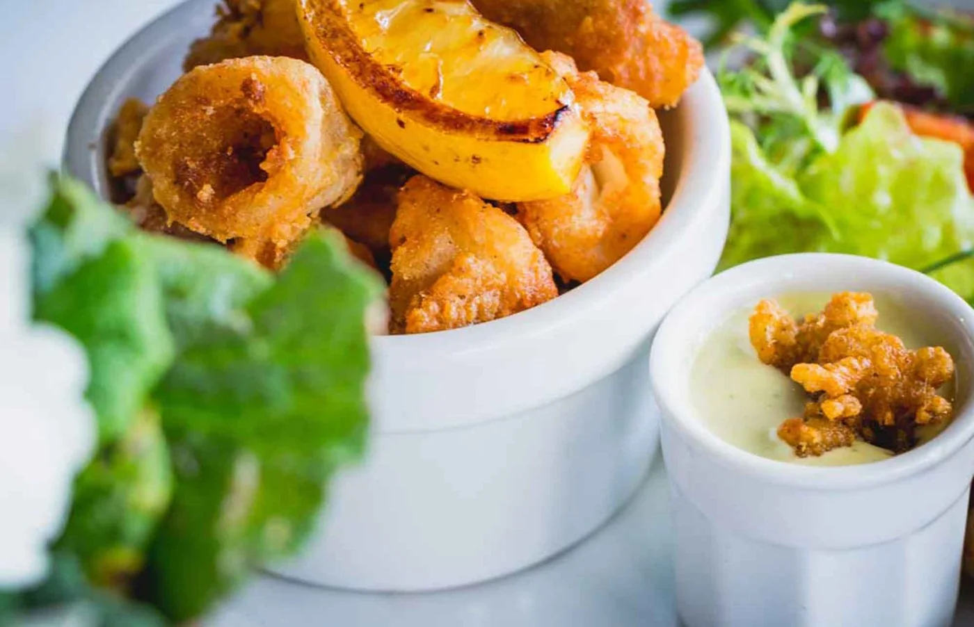 A golden crisp seafood dish with salad at Waterside Bistro