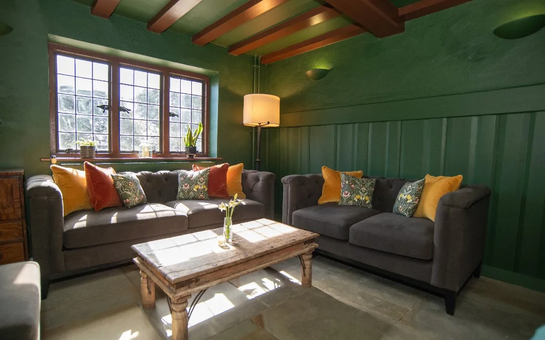Green-panelled snug with sofas at the White Hart