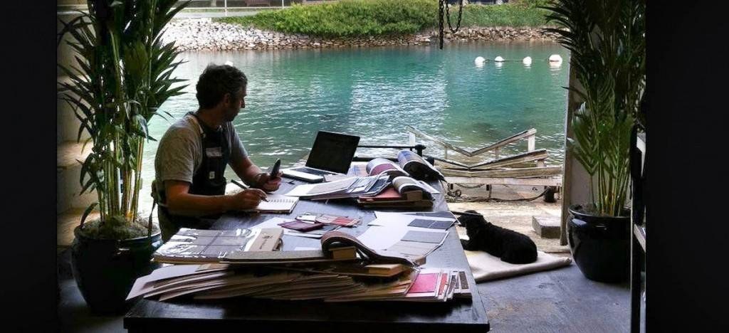A maker working beside a waterside window in the Will Bees Bespoke workshop