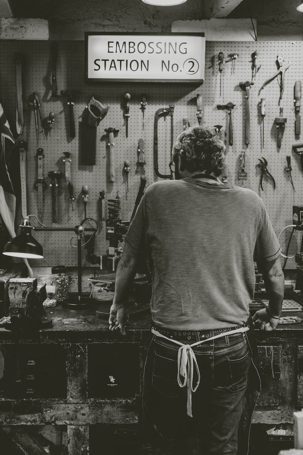 Black and white photograph of the embossing station at Will Bees Bespoke