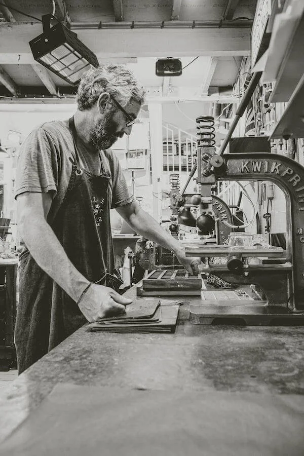 Black and white photograph of leather work in the workshop