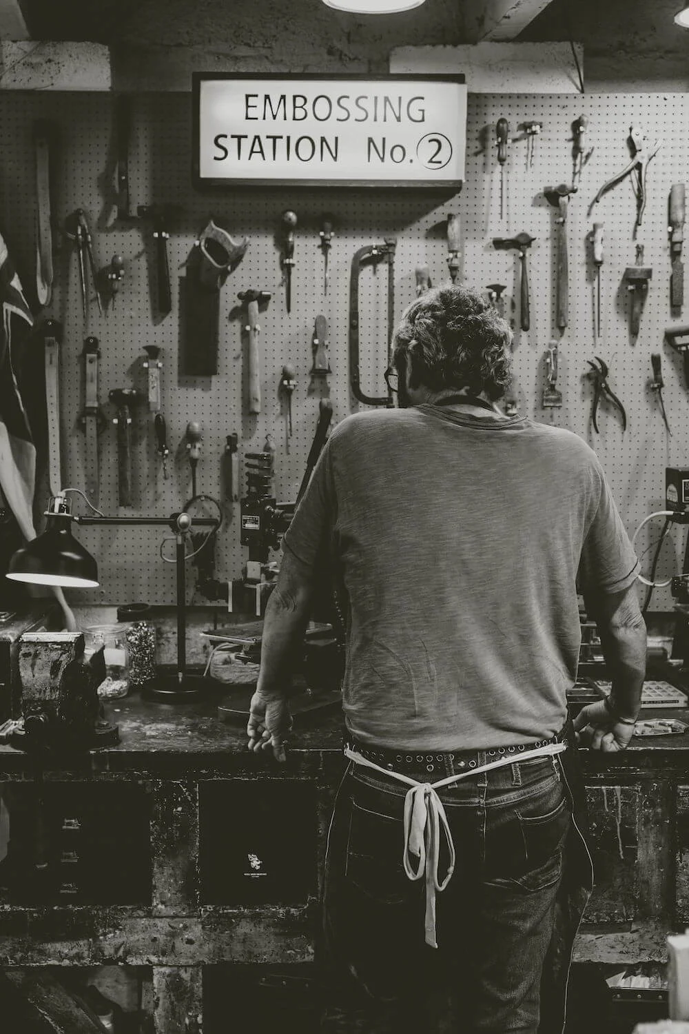 Black and white photograph of the embossing station