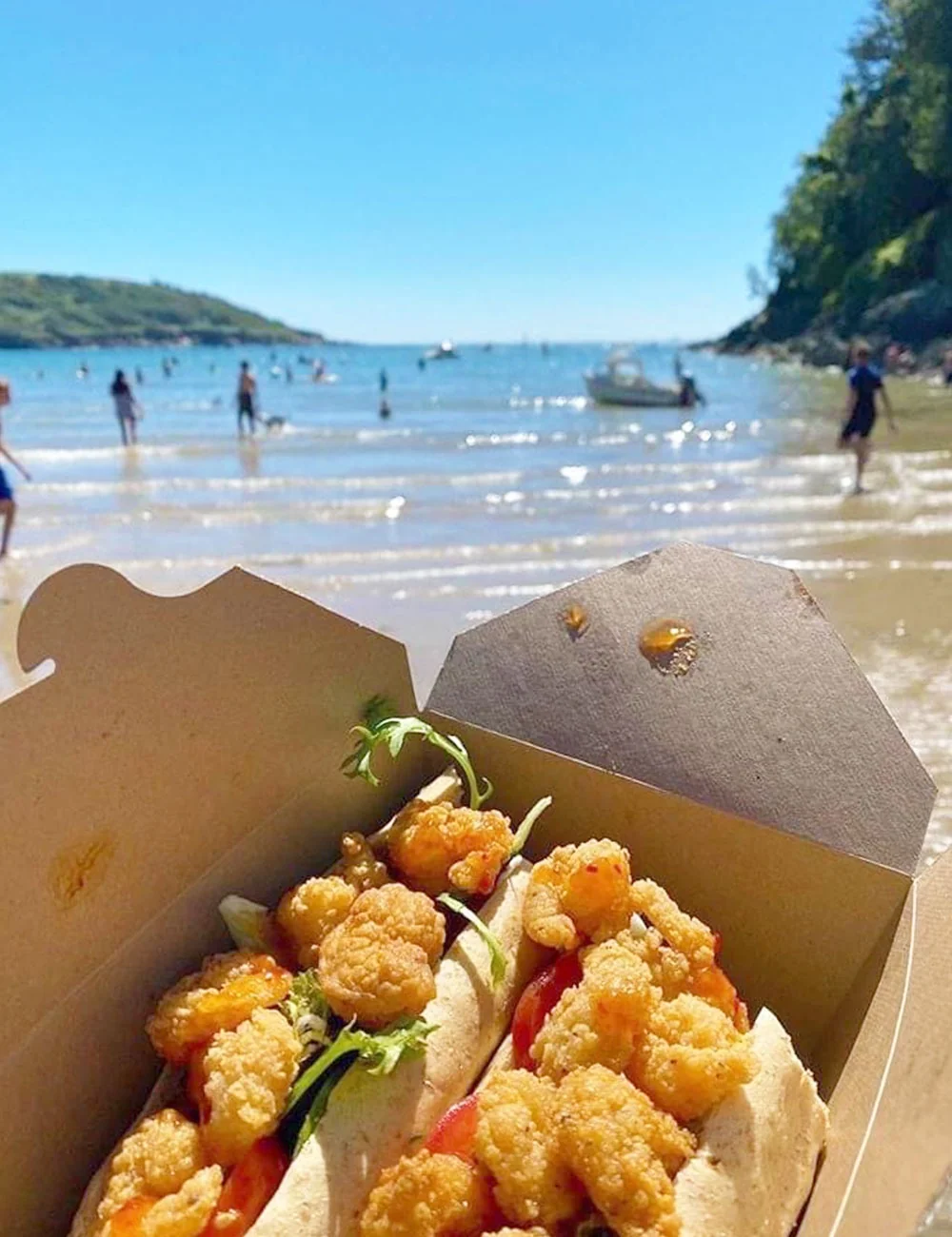 Takeaway shrimp and chips with North Sands beach in the background